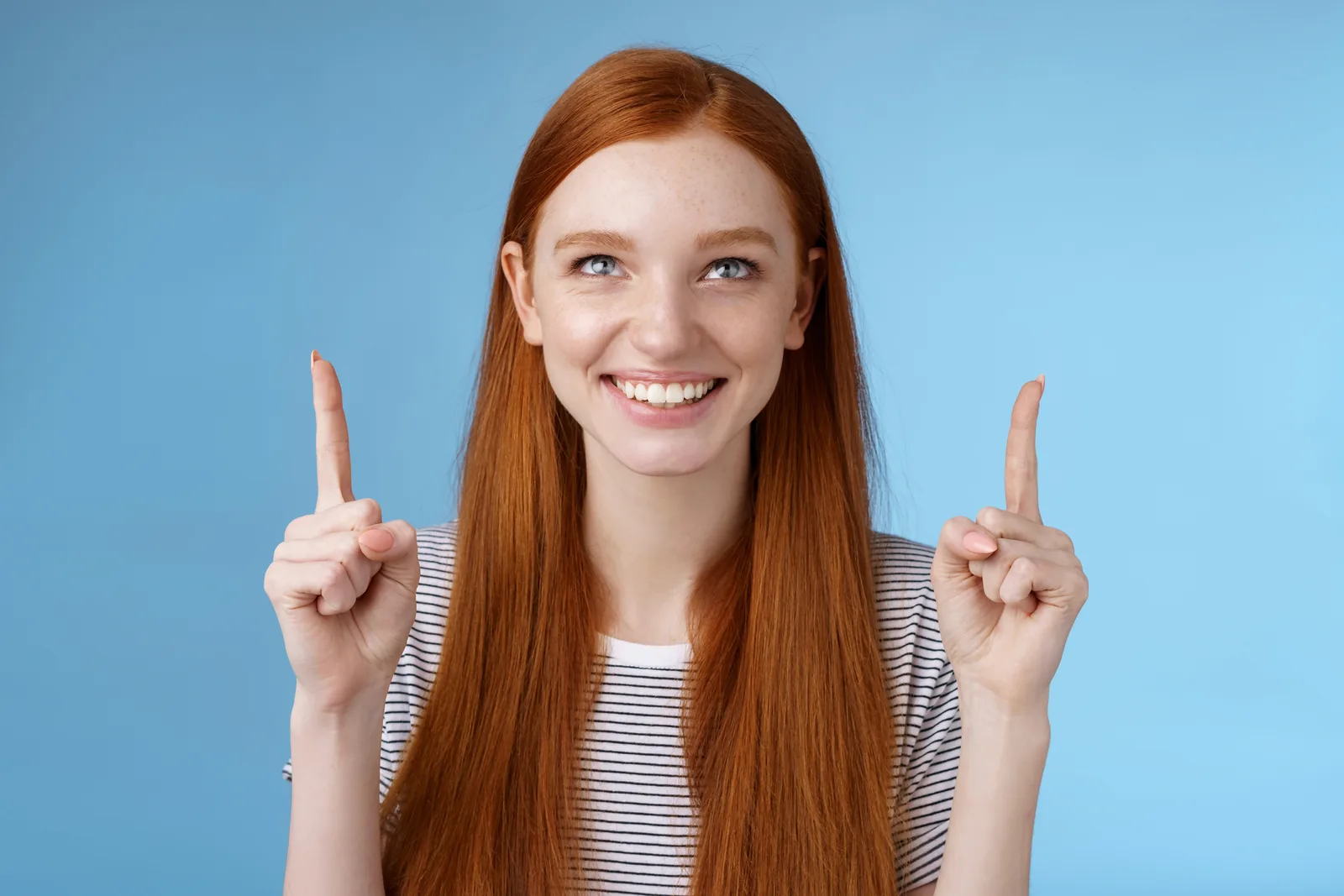 Smiling woman points up, indicating growth for SEO services Ireland.