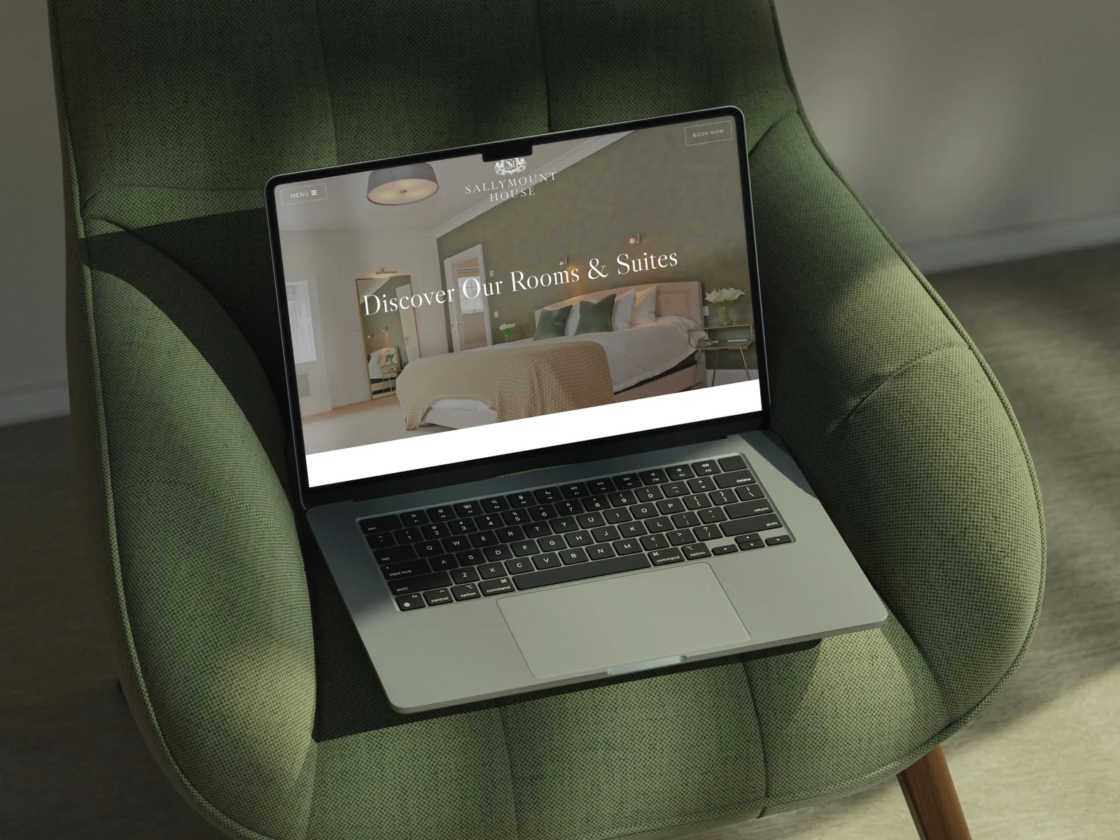website design displaying hotel rooms and booking CTA on a laptop.
