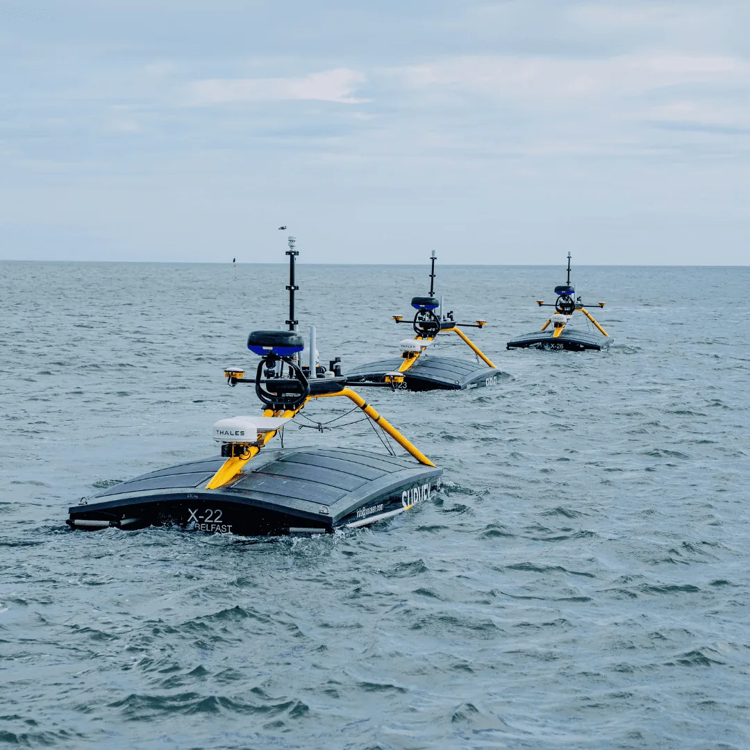 Three autonomous marine vessels on the sea, reflecting website design expertise.